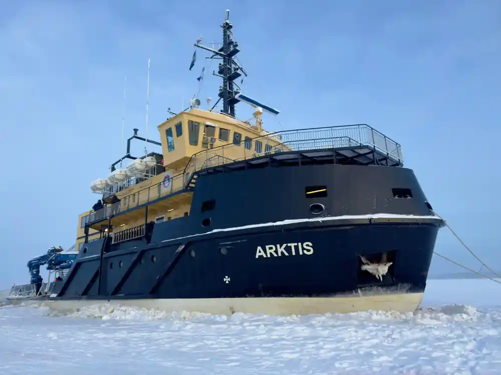 The bow of Arktis in the ice under a blue sky