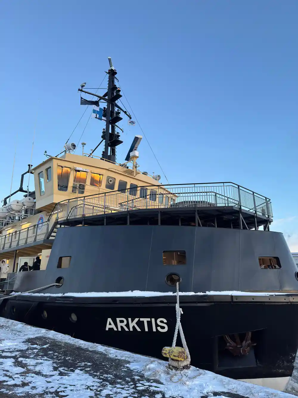 The bow of Arktis at the quay under a blue sky
