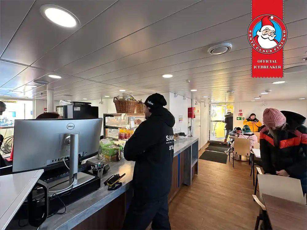 The cafe counter on board with a member of crew