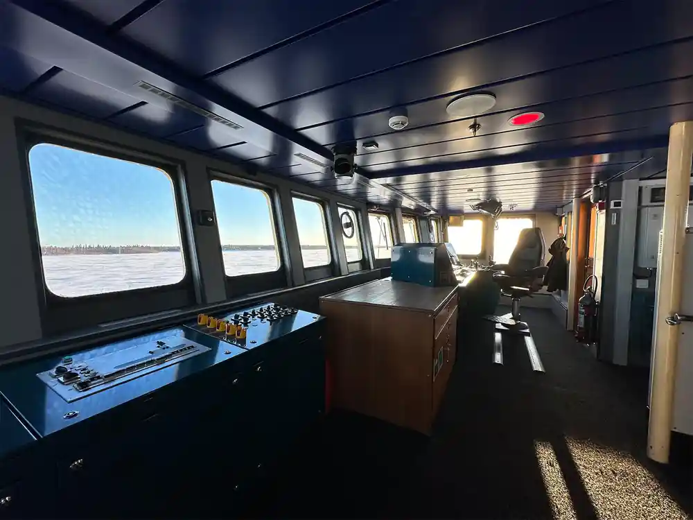 The interior of a heated passenger deck with windows over the ice
