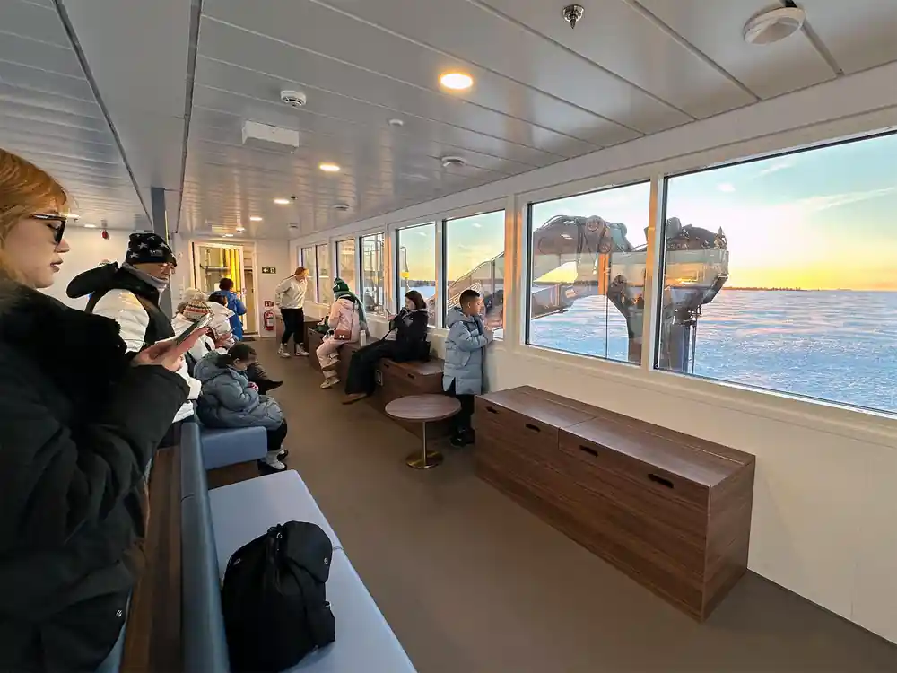 Passengers seated in the heated deck looking out over the ice