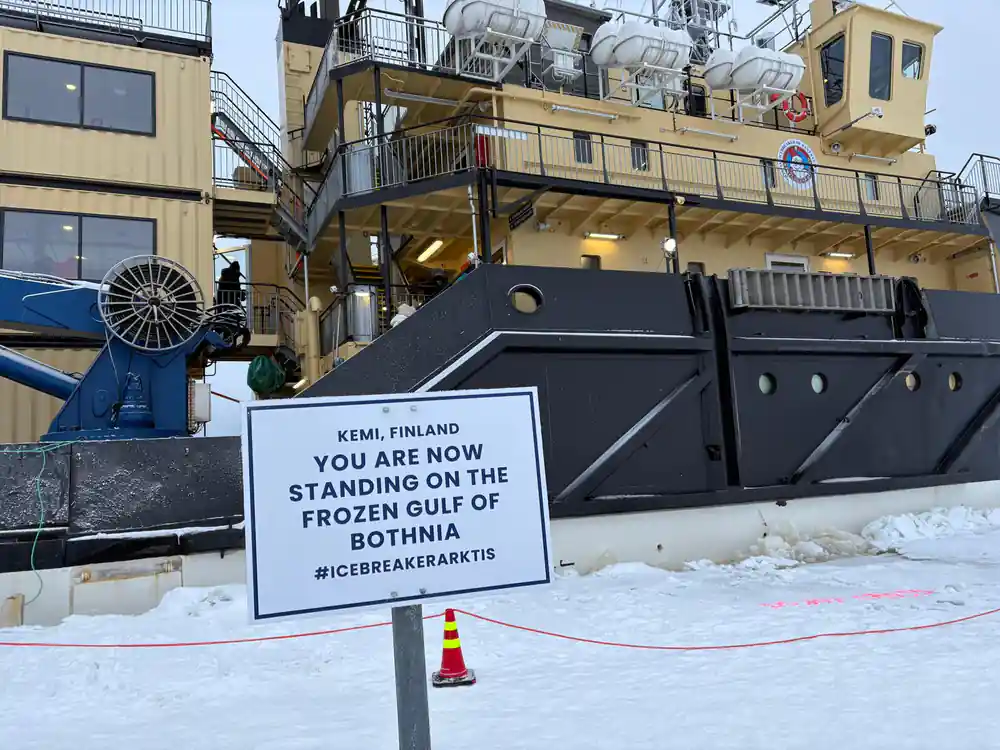 A sign at the ship reading that you are standing on the frozen Gulf of Bothnia